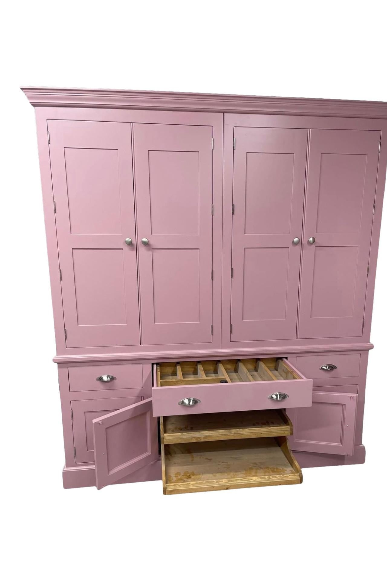 Pink wardrobe with open drawer on a white background