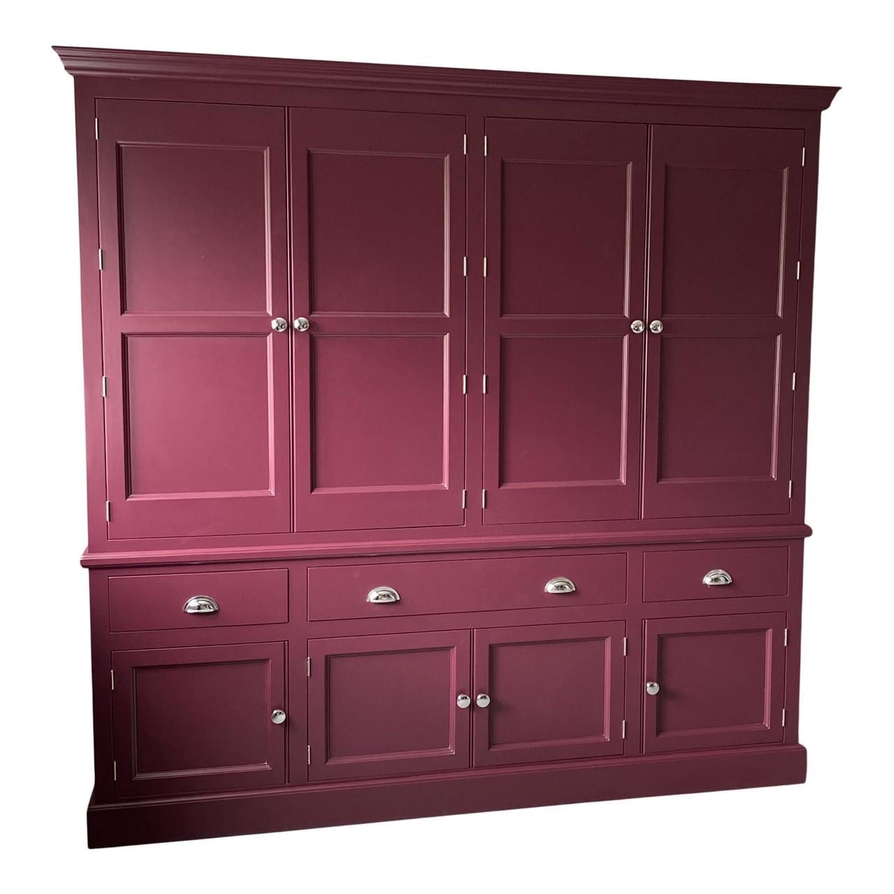 Maroon cabinet with multiple doors and drawers on a white background
